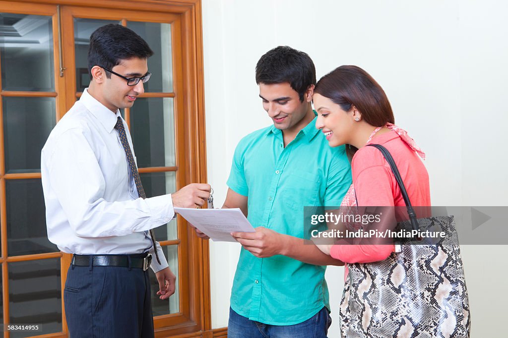 Agent selling property to young couple