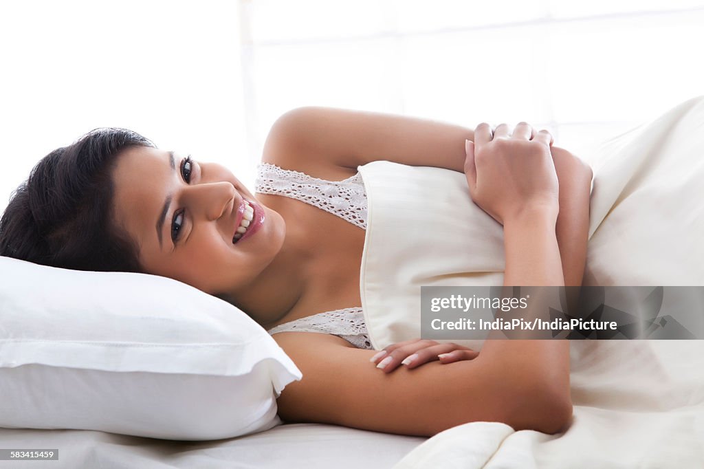 Portrait of girl lying on bed