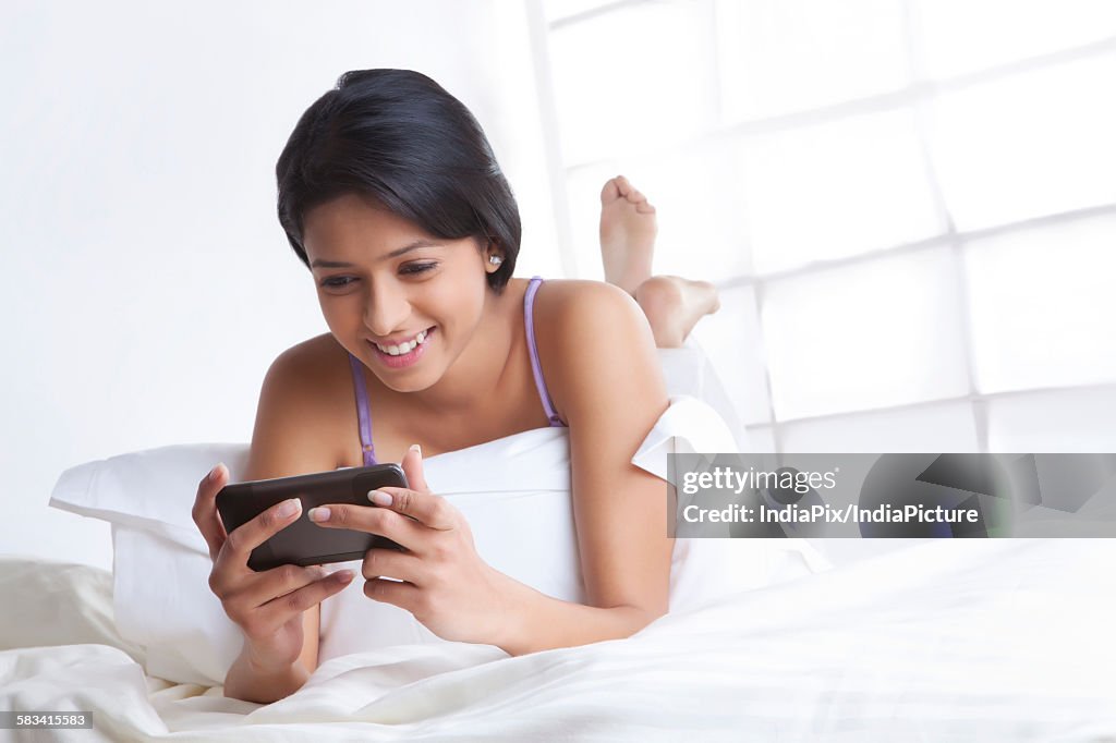 Girl reading sms on mobile phone