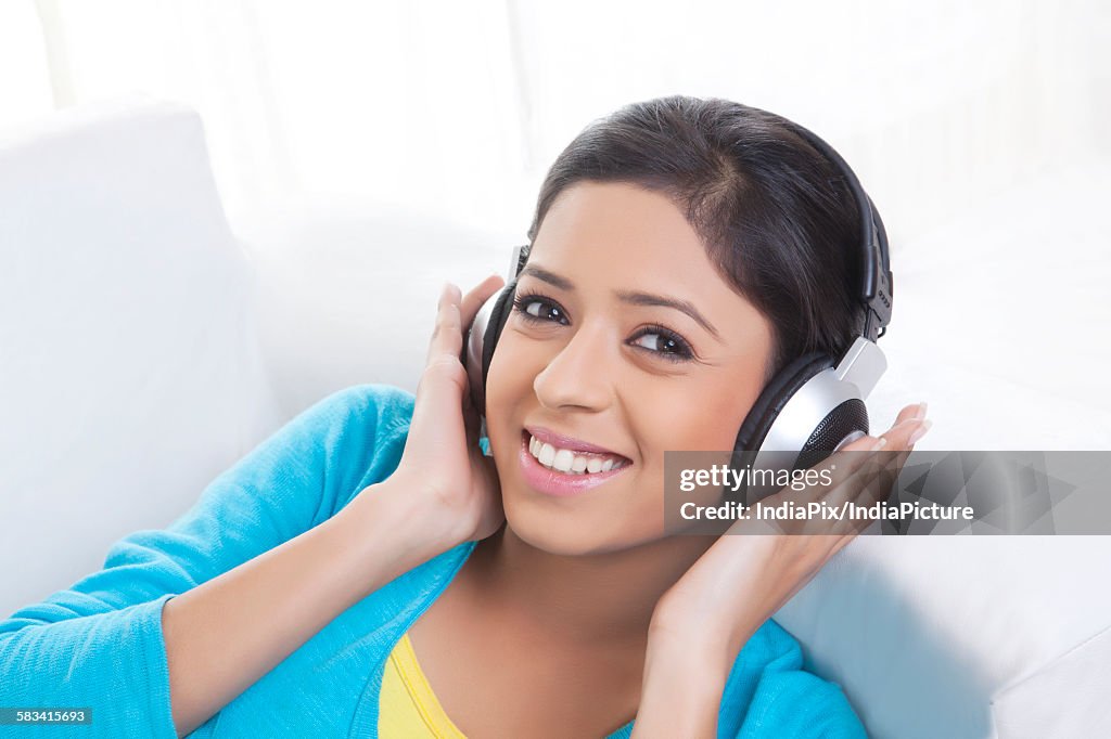 Portrait of girl with headphones listening to music