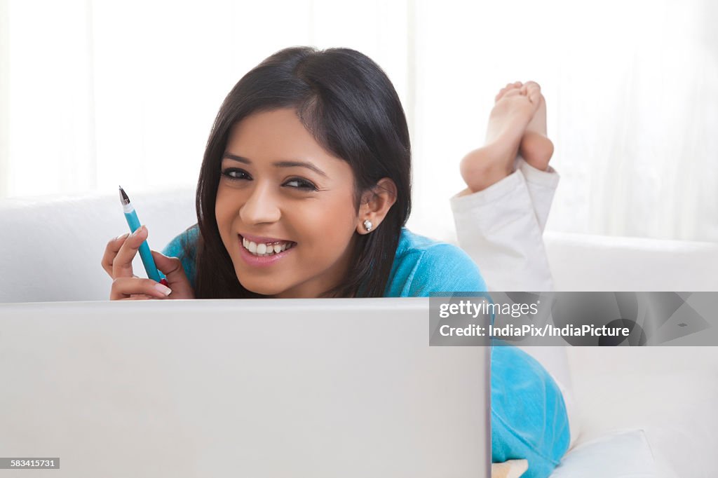 Portrait of girl with laptop smiling