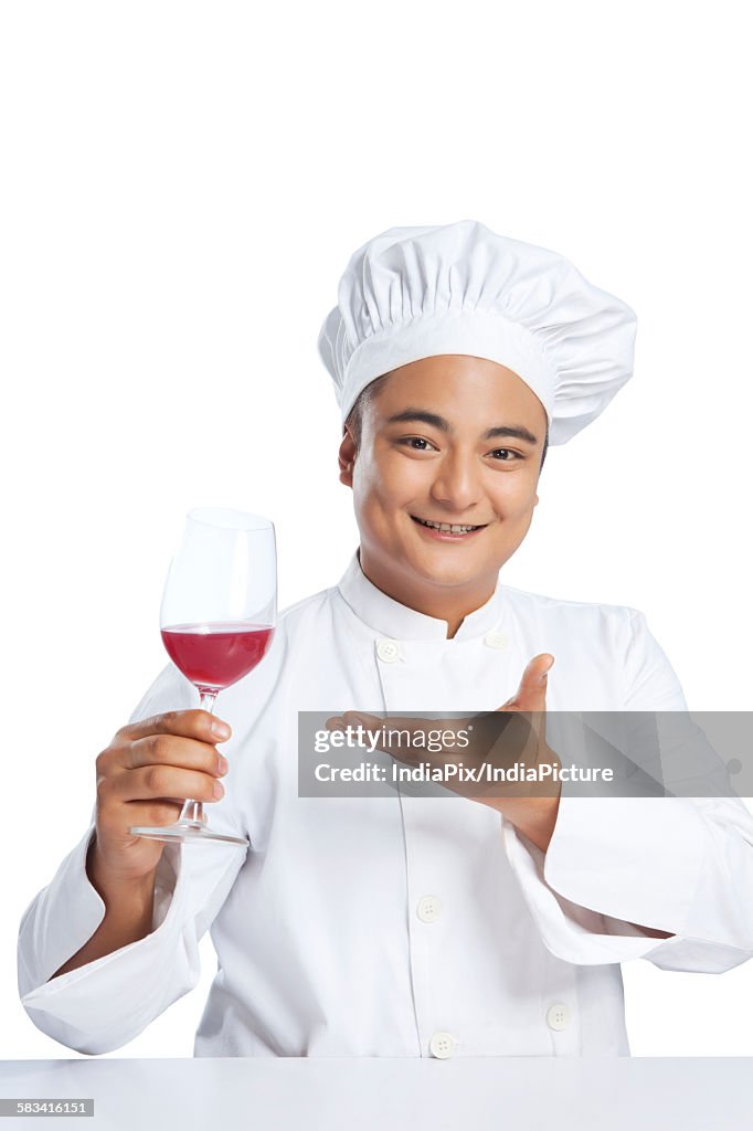 Portrait of chef with glass of wine