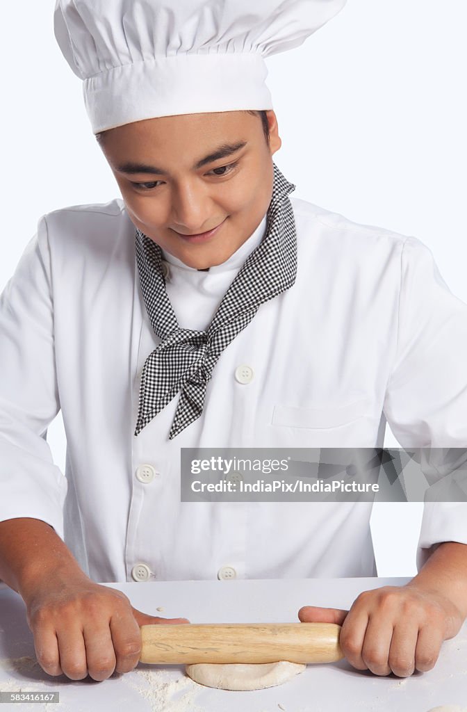 Chef rolling dough