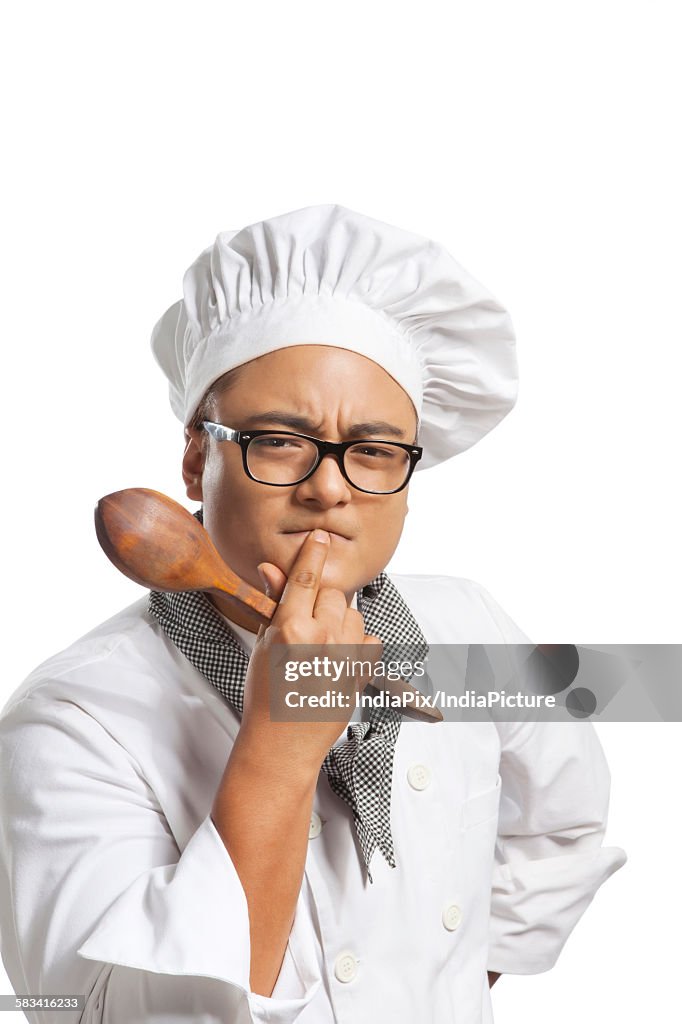Portrait of chef with wooden spoon thinking