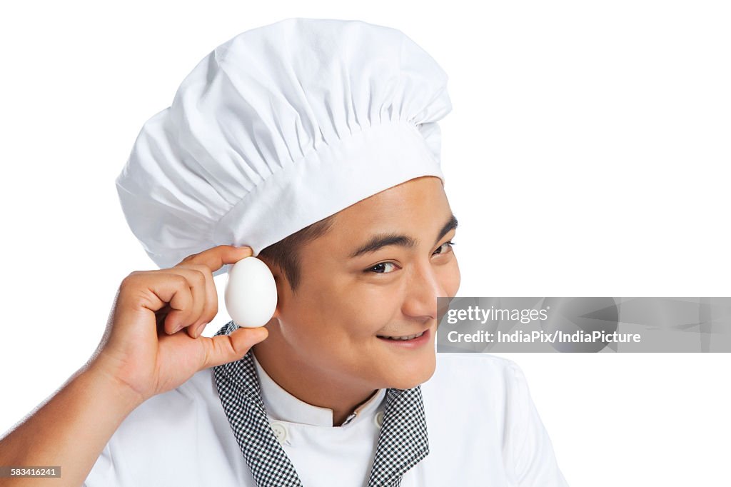 Chef listening to an egg