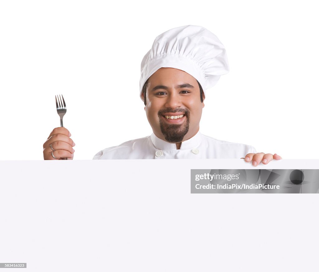 Portrait of chef with fork smiling