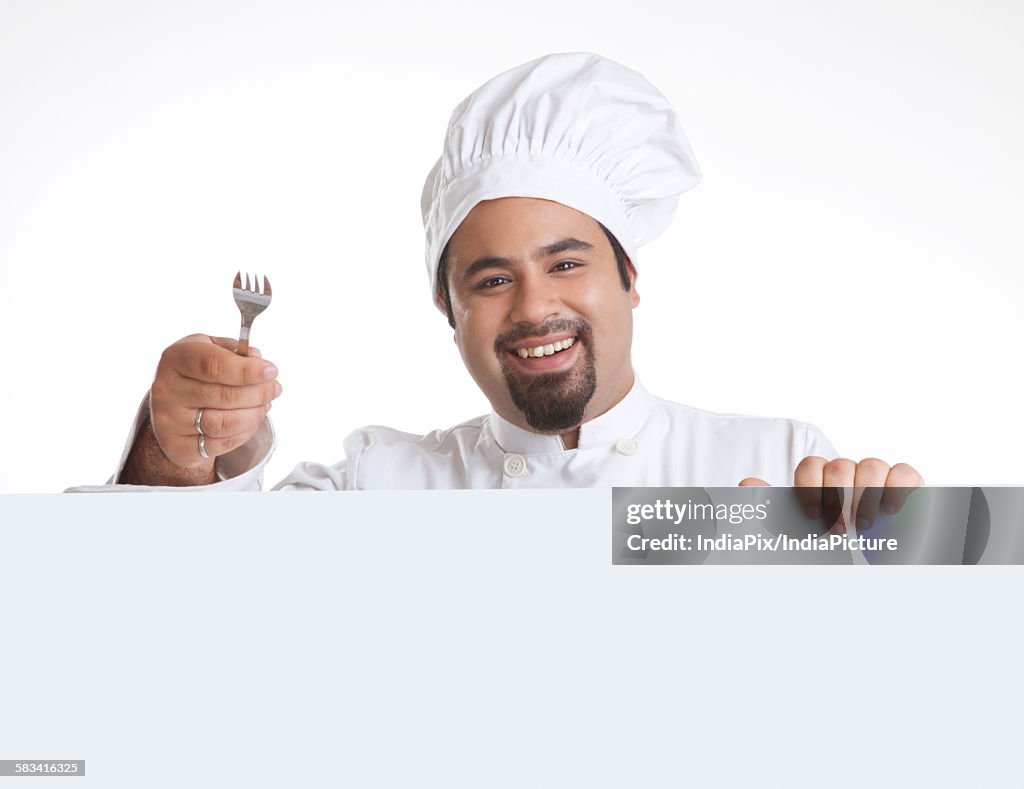Portrait of chef with fork smiling