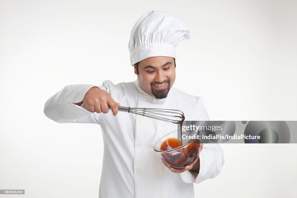 Chef mixing chocolate in a bowl