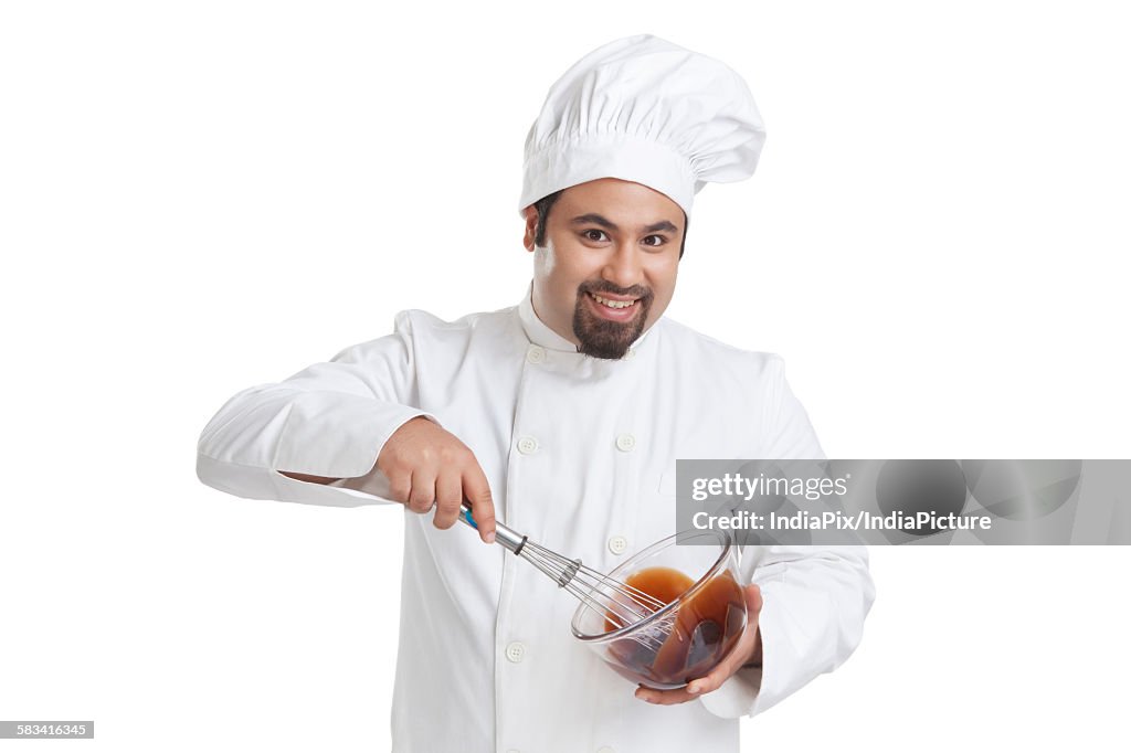 Portrait of chef mixing chocolate in a bowl