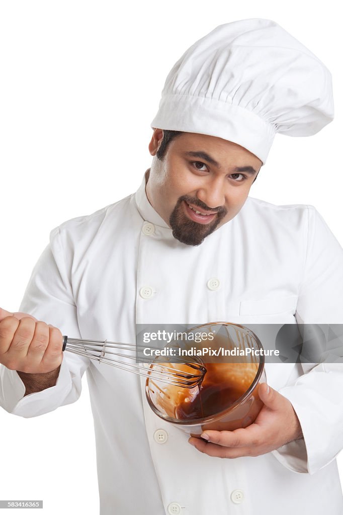 Portrait of chef mixing chocolate in a bowl