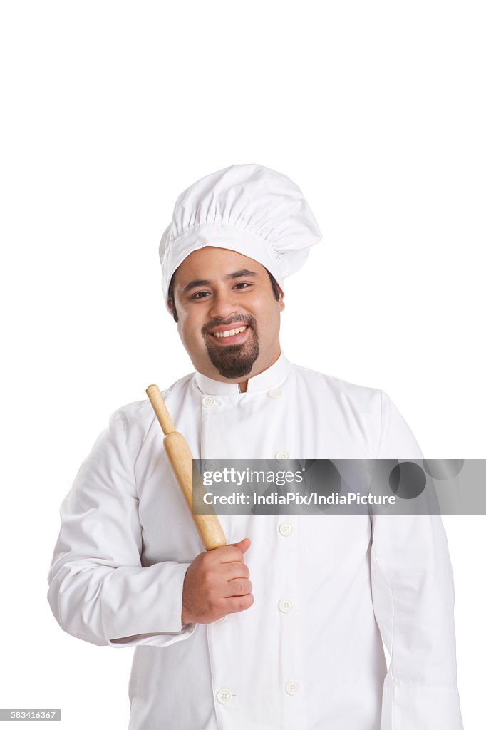 Portrait of chef holding a rolling pin