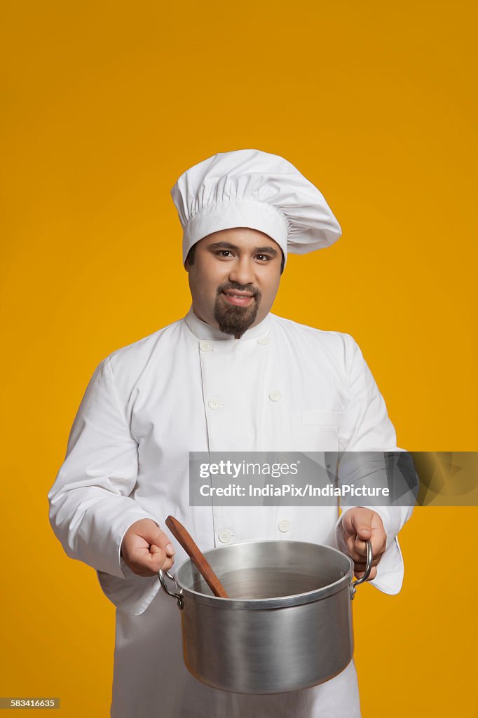 Portrait of chef holding utensil