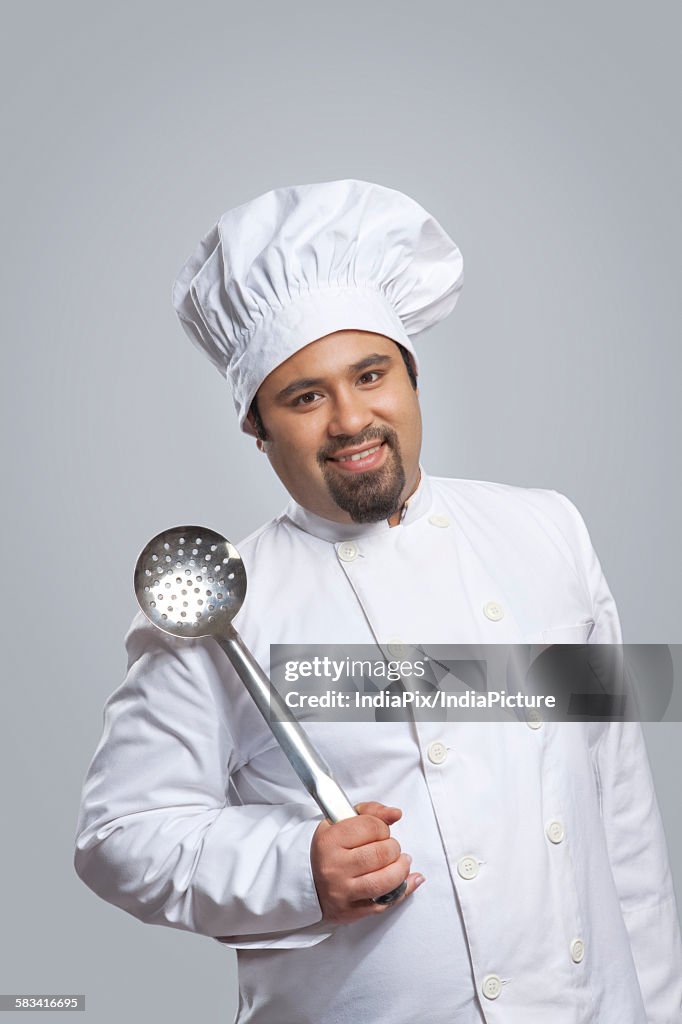 Portrait of chef holding a skimmer