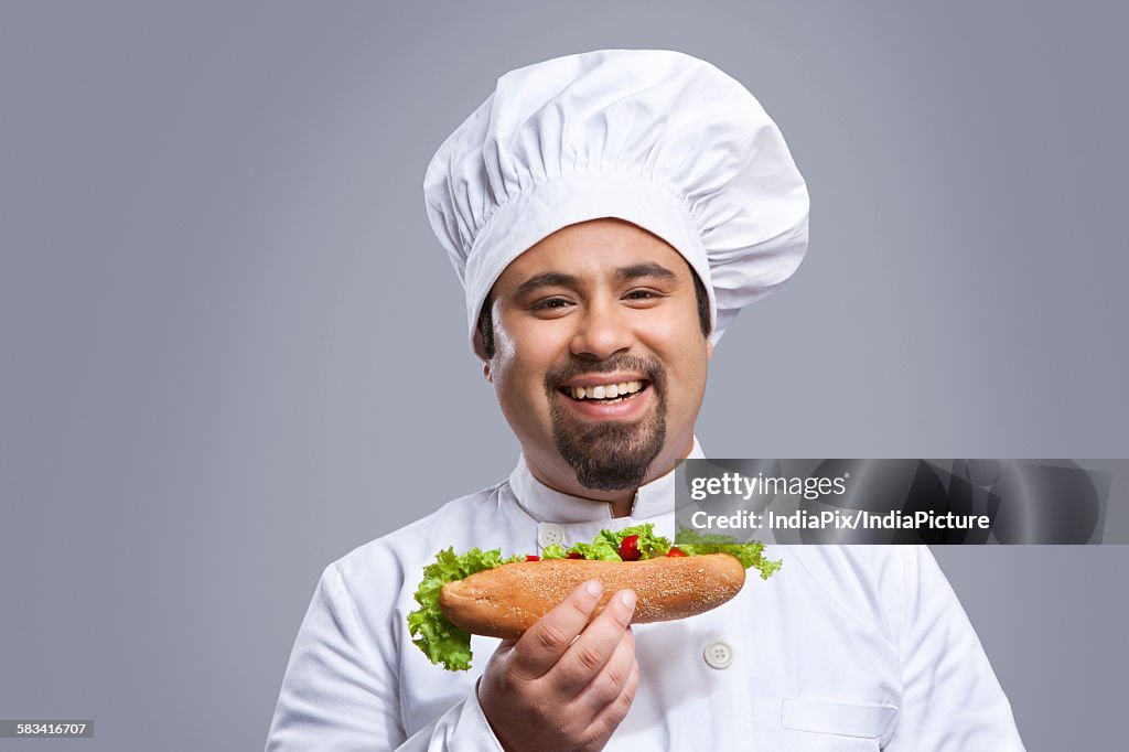 Portrait of chef with sandwich smiling
