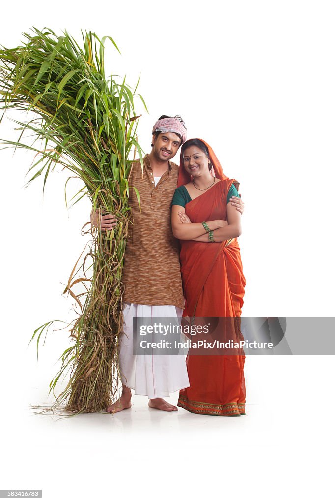Portrait of rural couple with fodder