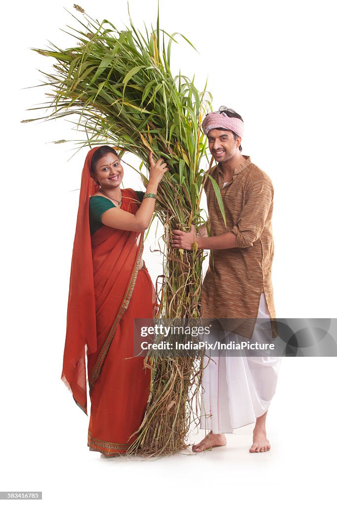 Portrait of rural couple with fodder