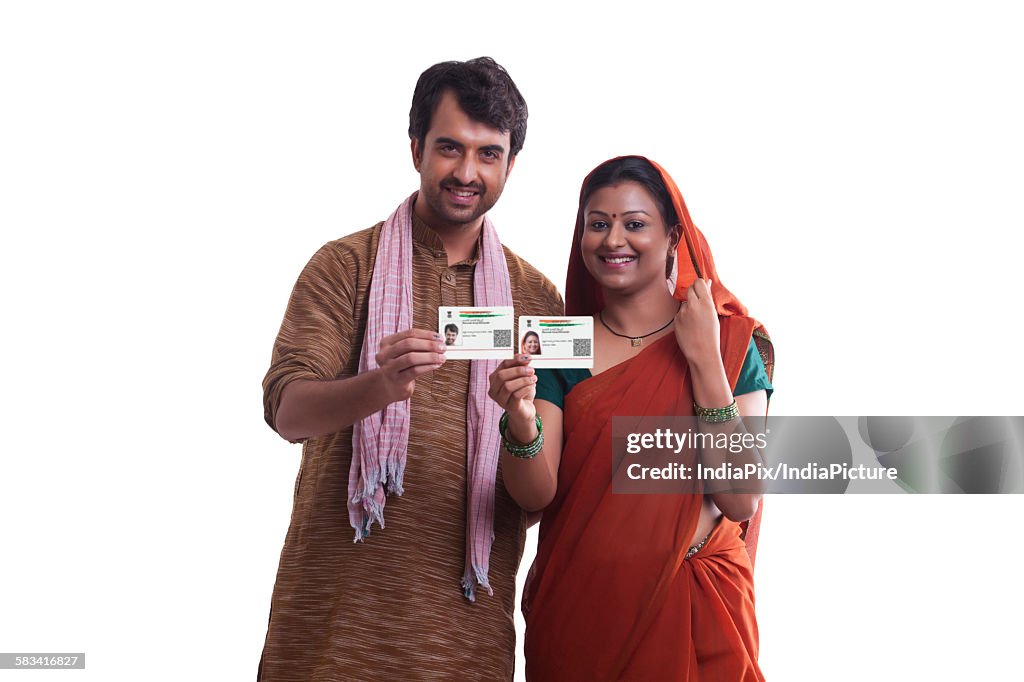 Portrait of rural couple with id cards