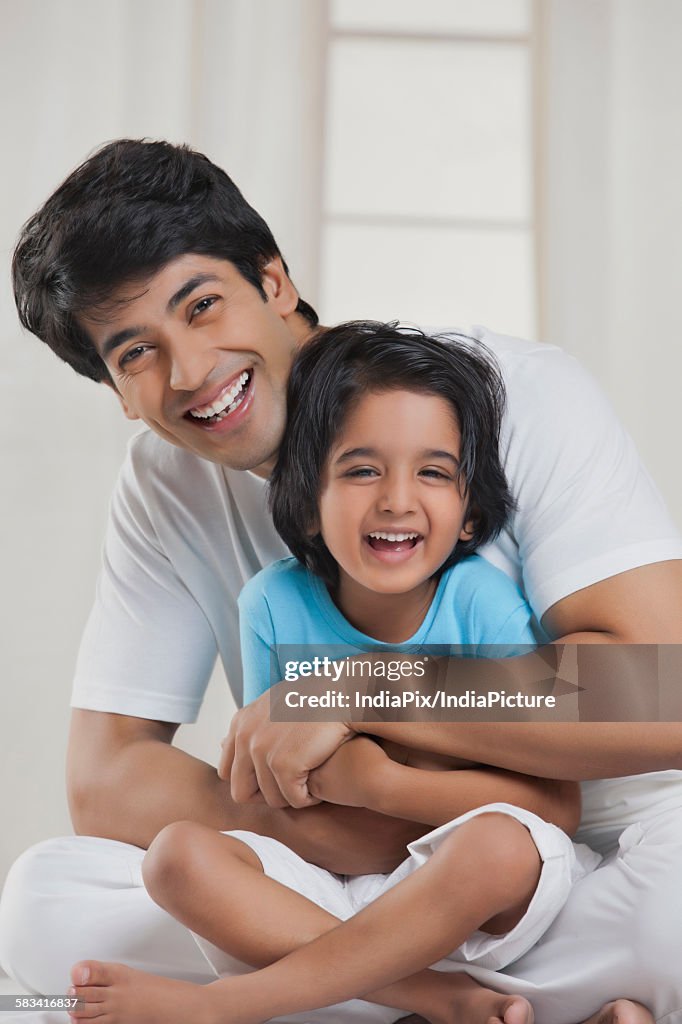 Portrait of father and son smiling