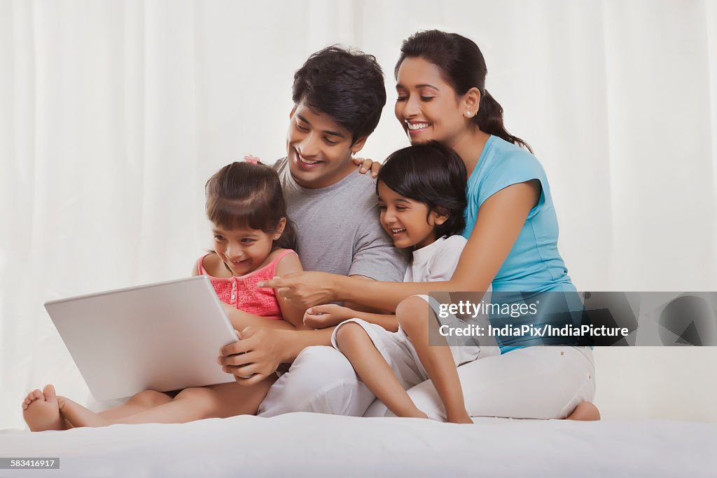 Family looking at laptop