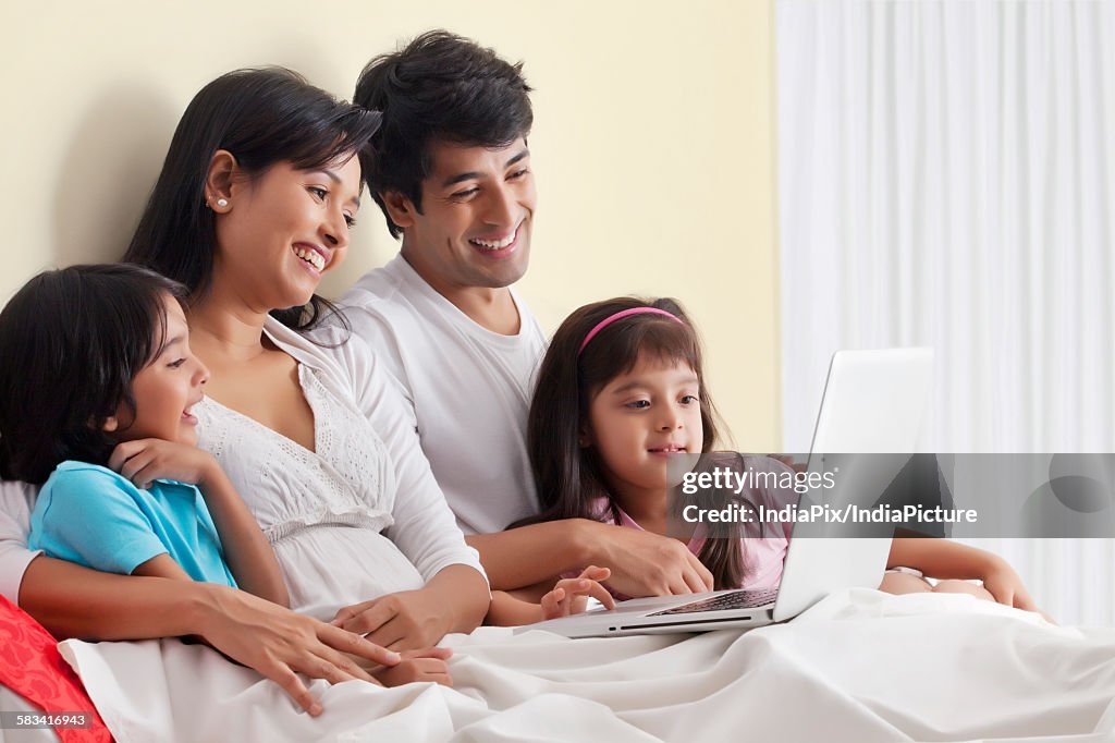 Family looking at laptop