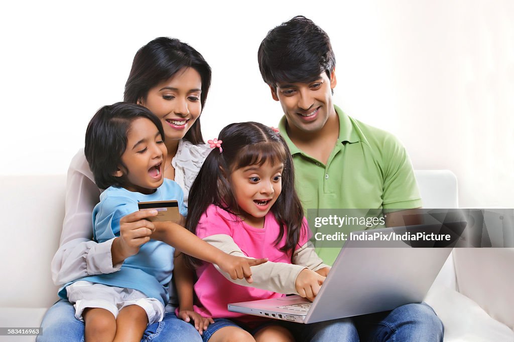 Family with laptop and credit card