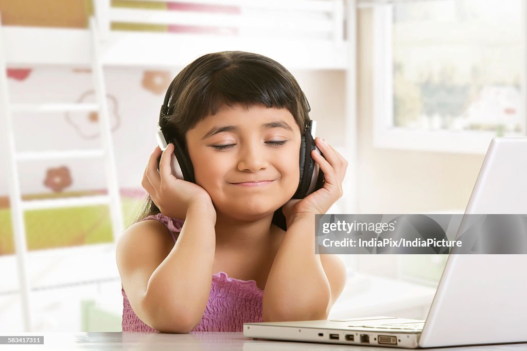 Girl listening to music on headphones