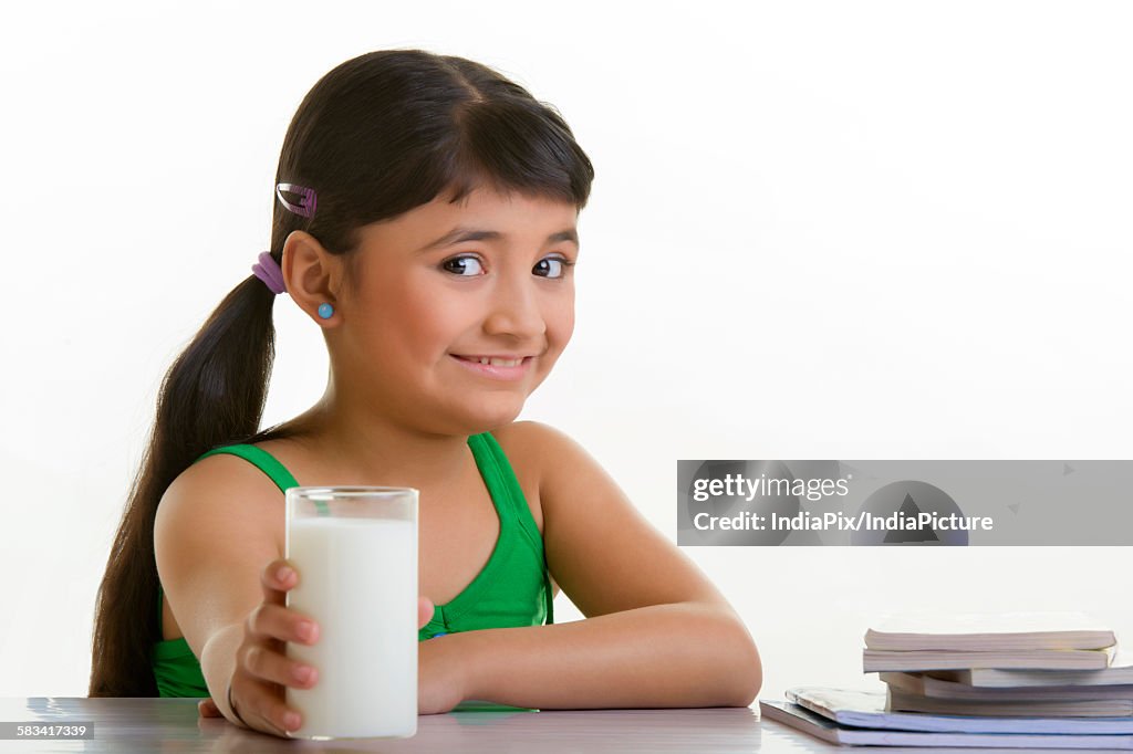 Girl holding a glass of milk