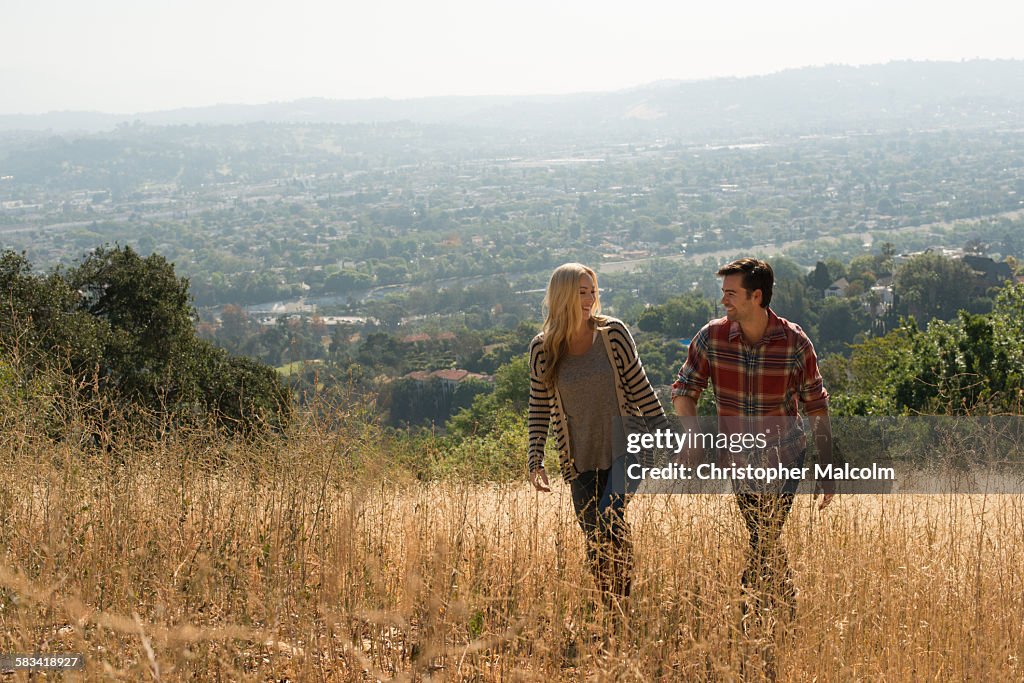 Young couple in nature holding hands
