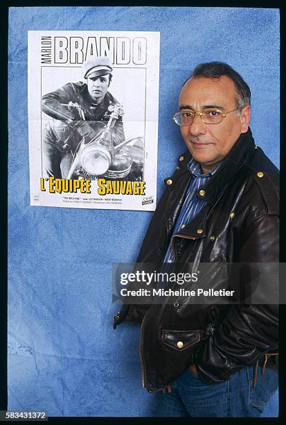 Yves Mourousi beside a poster of American actor Marlon Brando.