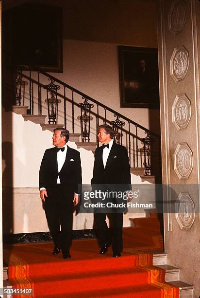 German Chancellor Helmut Schmidt, left, walks alongside American President Jimmy Carter, at a White House reception, Washington, DC, March 1980.