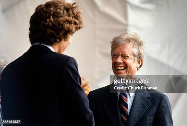 American President Jimmy Carter smiles while speaking with John F Kennedy Jr, at the dedication ceremony for the John F. Kennedy Presidential Library...