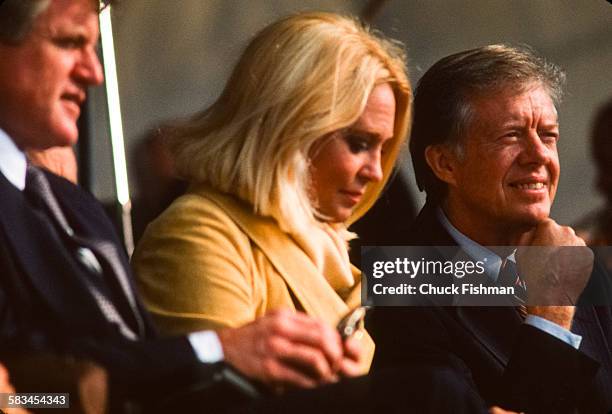 Senator Ted Kennedy, left, sits with his wife Joan, center, next to President Jimmy Carter, right, at the memorial dedication ceremony for the JFK...
