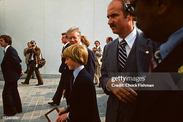 President Jimmy Carter walks alongside Patrick Kennedy, son of Senator Edward Kennedy, at the dedication ceremony for the John F. Kennedy...