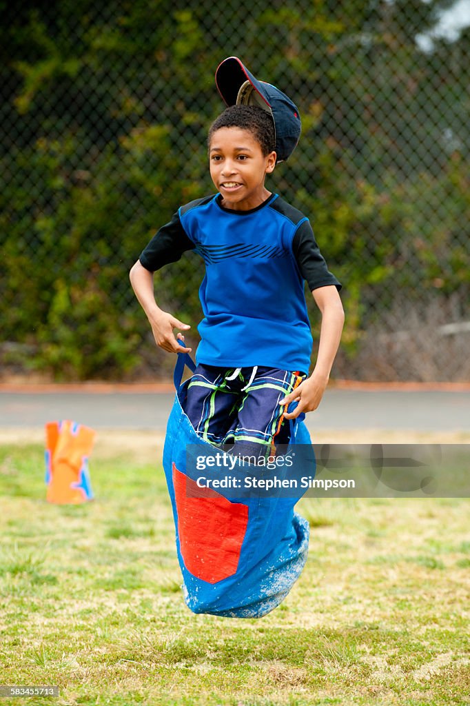 Boy leaping in school sack race