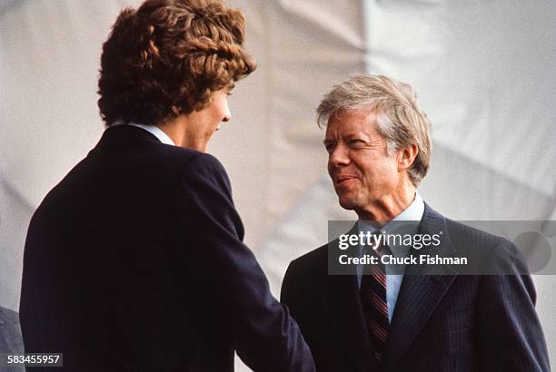American President Jimmy Carter speaks with John F Kennedy Jr, at the dedication ceremony for the John F. Kennedy Presidential Library and Museum in...