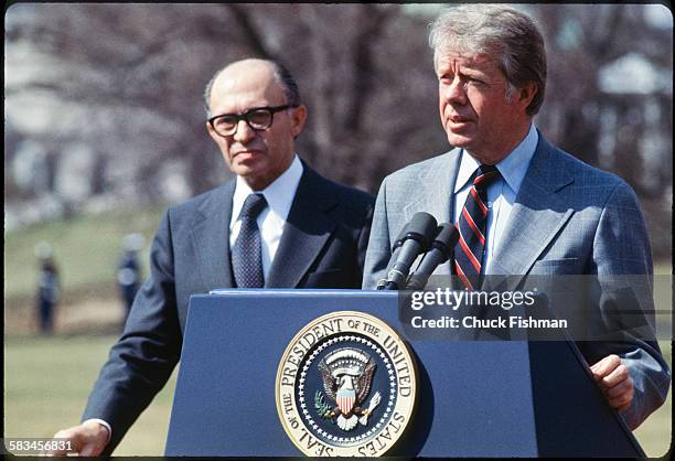 United States President Jimmy Carter stands on the podium with Israeli Prime Minister Menachem Begin behind him, while addressing the press after a...