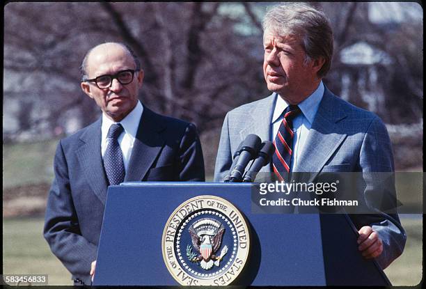 United States President Jimmy Carter stands on the podium with Israeli Prime Minister Menachem Begin behind him, while addressing the press after a...