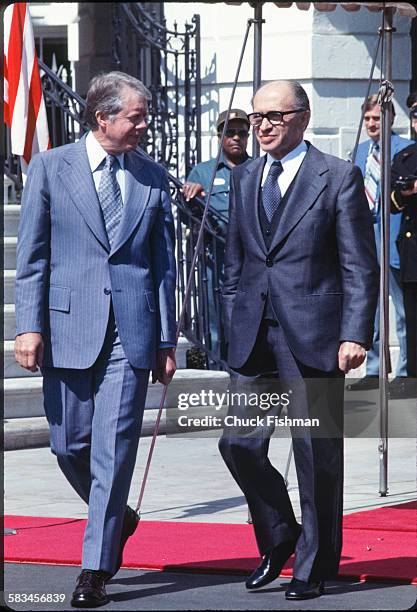 United States President Jimmy Carter, left, walks and converses with Israeli Prime Minister Menachem Begin outside the Oval Office at the White...