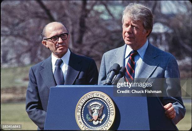 United States President Jimmy Carter stands on the podium with Israeli Prime Minister Menachem Begin behind him, while addressing the press after a...