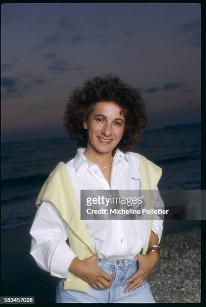 French singer, Marie Paule Belle, enjoys an eveing stroll on the beach of Deauville.