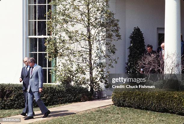 United States President Jimmy Carter, right, walks and converses with Israeli Prime Minister Menachem Begin outside the Oval Office at the White...