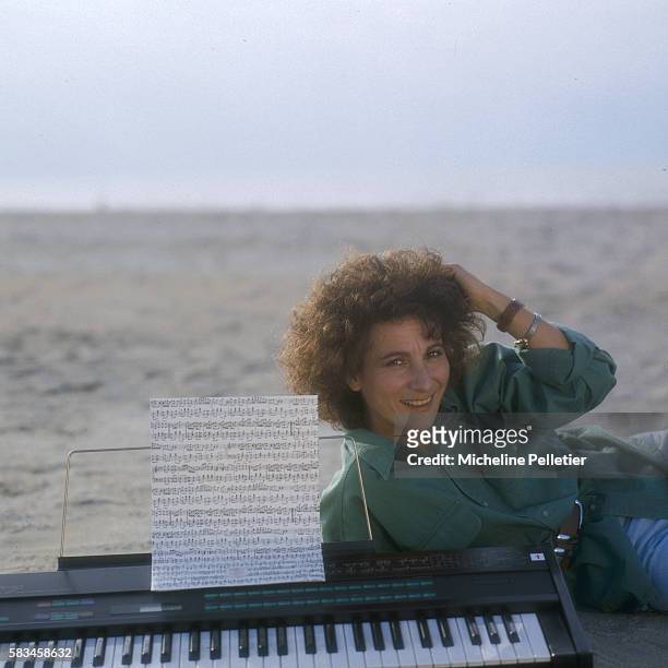 French singer, Marie Paule Belle, poses with her keyboard on the beach of Deauville.