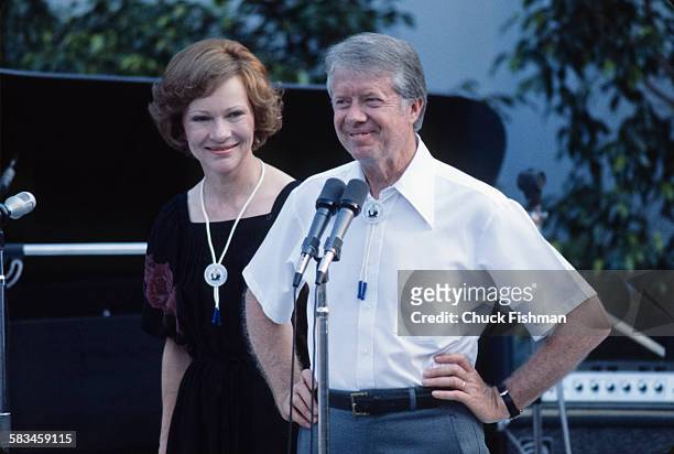 President Jimmy Carter, with First Lady Rosalynn behind, addresses the crowd from the stage at a White House Jazz Concert on the south lawn, on the...