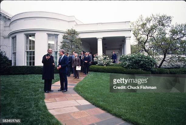 President Jimmy Carter, right, speaks and walks with Egyptian President Anwar Sadat as they leave the White House after exiting the Oval Office,...