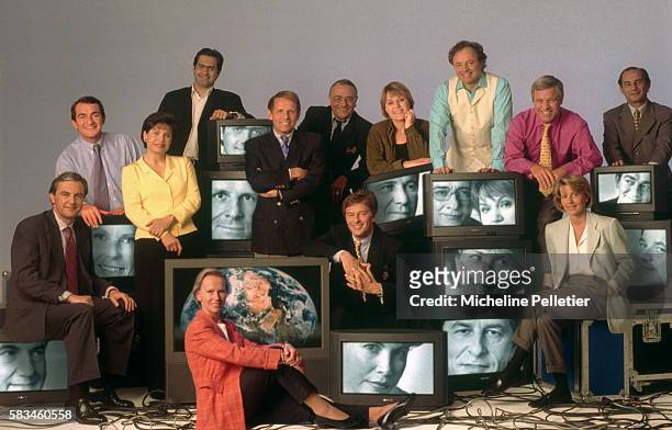 Group of prominent French journalists gather around stacks of television sets. Pictured are Marie-Laurie Aubry, Emmanuel Chain, Claire Chazal,...