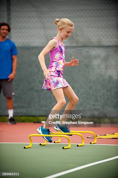young girl in tennis camp drills - sportoefening stockfoto's en -beelden