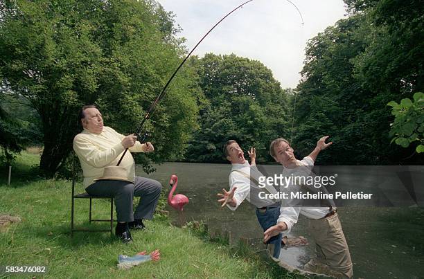 Belgian comedian Raymond Devos hooks comedy team the Taloche Brothers on his fishing line at the edge of a river. Bruno Taloche and Vincent Taloche...