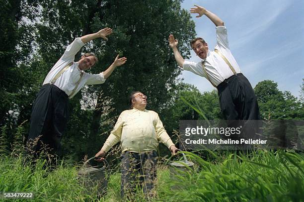 Belgian comedian Raymond Devos looks up as the Taloche Brothers jump into the air next to him. Bruno Taloche and Vincent Taloche are two Belgian...