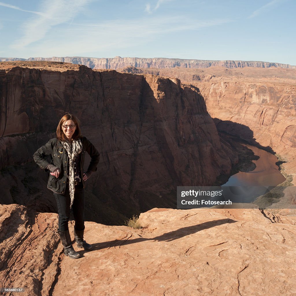 Woman standing on a rock at Horseshoe Bend