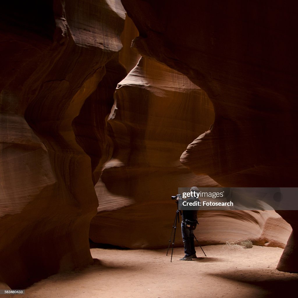 Man photographing in a slot canyon